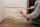 A man from the insurance company measures the damage on the wall